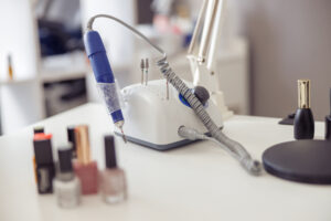 Photo of professional nail care tools for manicure on working table in nail art studio